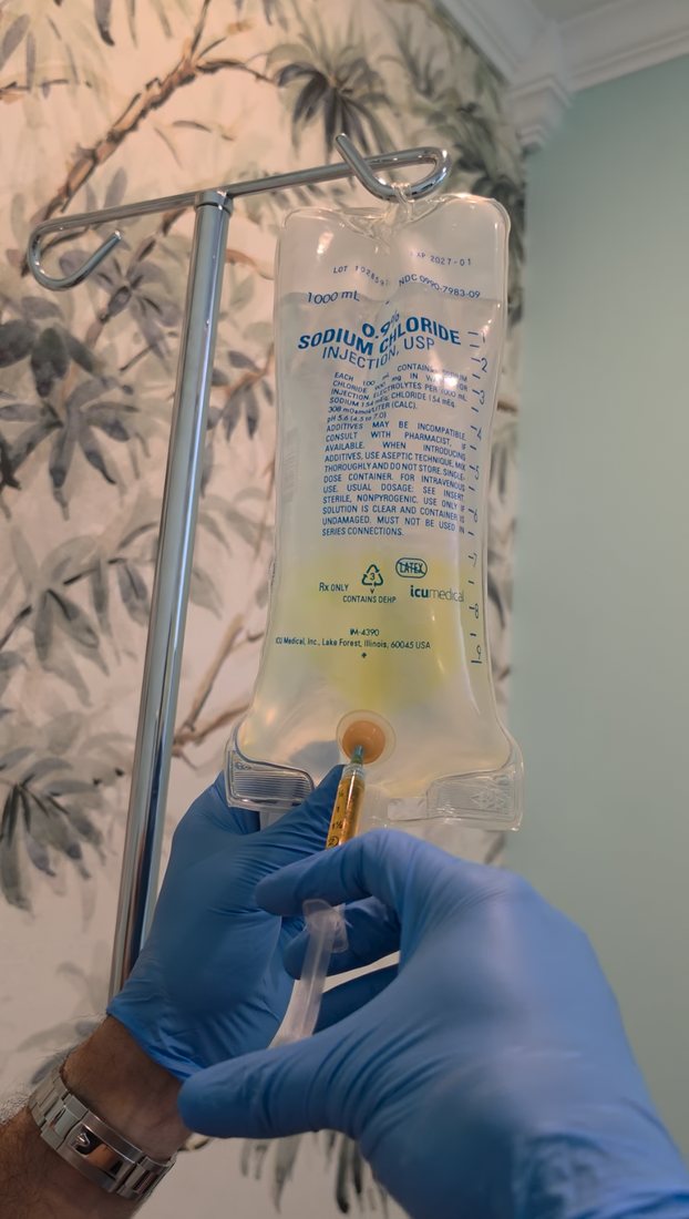 A physician-supervised team member preparing a custom IV vitamin drip at Serene Med Spa